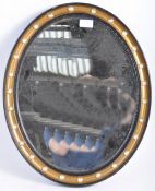 A VICTORIAN IRISH STYLE ANTIQUE EBONY AND GILT OVAL WALL MIRROR