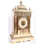A 19TH CENTURY VICTORIAN POLISHED BRASS CASED TABLE CLOCK HOUSING A BRASS MOVEMENT