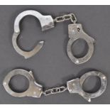 TWO PAIRS OF VINTAGE POLICE HANDCUFFS