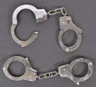 TWO PAIRS OF VINTAGE POLICE HANDCUFFS