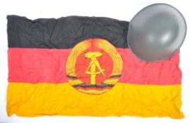 EAST GERMAN GUARD'S HELMET & ORIGINAL FLAG