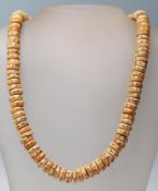 An 20th century bone carved beaded necklace having