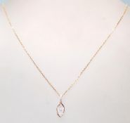 An 18ct rose gold necklace having a oval shaped pe