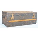 An early 20th century wooden bound steamer trunk w