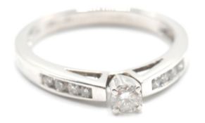 A white gold ladies dress ring having a central di