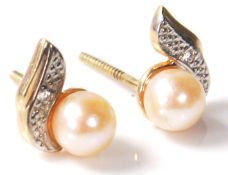 A pair of 20th Century pearl and diamond earrings