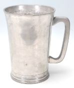 An antique half-gallon pewter tanker in a tapered