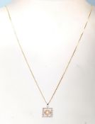 A 14ct mixed gold and diamond necklace having a pe