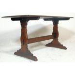 A 20th Century Ercol Old Colonial oak dark wood refectory dining table raised on Windsor supports