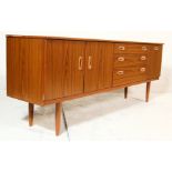 A vintage 20th century retro teakwood sideboard having a bank of three graduated drawers flanked