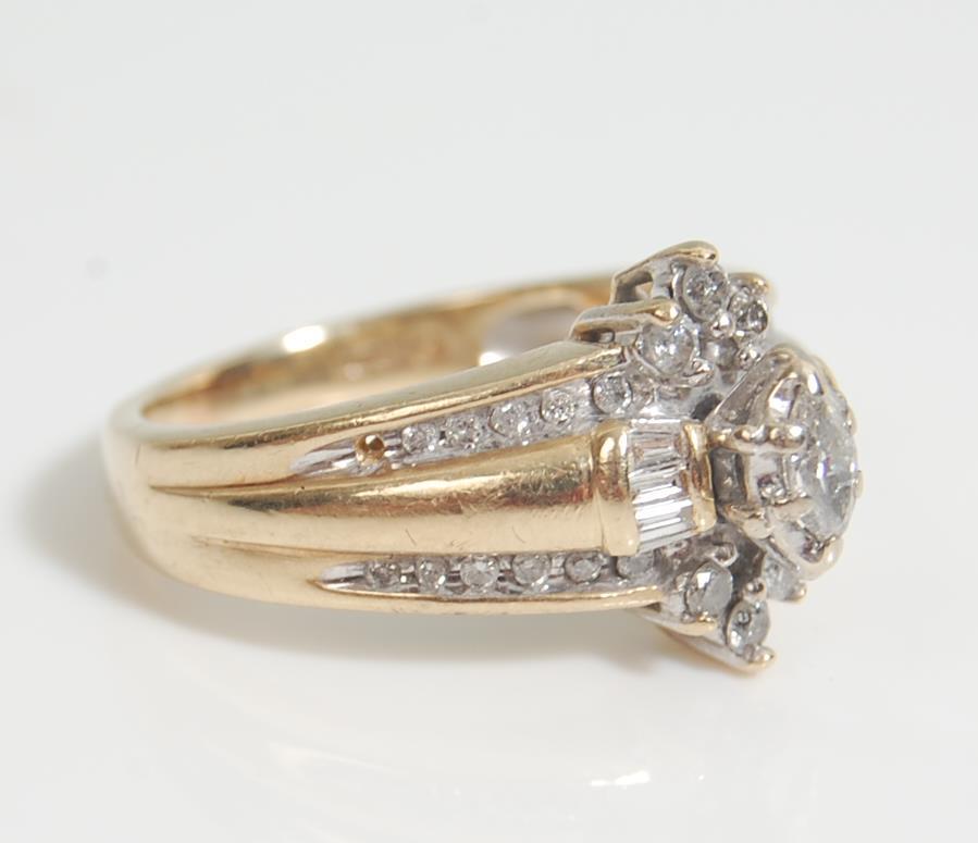 A 14 ct gold and diamond ladies ring having a central marquise cut diamond with further round and - Image 2 of 7