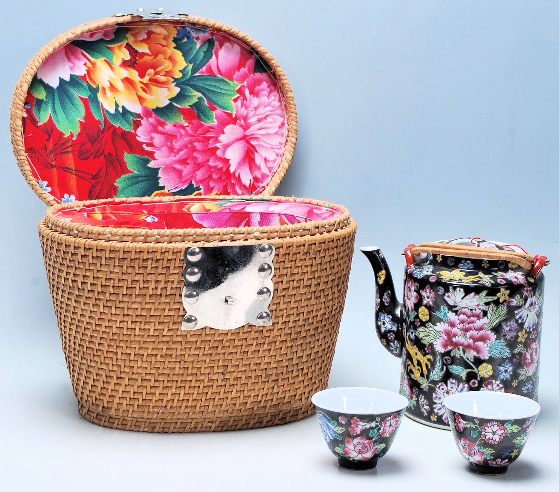 A vintage Chinese 20th Century Chinese tea set having a cylindrical teapot with a black ground