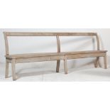 A 19th century Victorian elm wood station / railway / factory bench of rustic simple form. Raised on