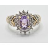 A ladies 9ct gold dress ring being set with an oval cut amethyst set with diamond accent stones with