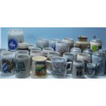A collection of 20th Century German ceramic stein drinking tankards, each having painted advertising