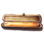 A vintage Aonian ivory cheroot holder having a 9ct gold collar housed within its original fitted