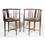 A pair of Edwardian early 20th Century corner oak corner chairs having horseshoe shaped inlaid