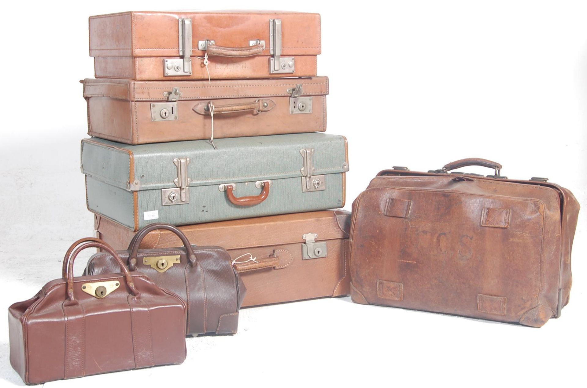 A good stack of vintage trunks and suitcases to include good leather example with monogram initials,