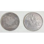 A pair of antique British silver crowns. One coin is dated 1822 with St George killing the dragon to