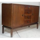 A mid-century retro circa 1950’s Vanson mahogany sideboard credenza being raised on squared legs