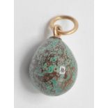 A 20th Century Russian egg pendant having a mottled blue and brown stone egg mounted on a gold