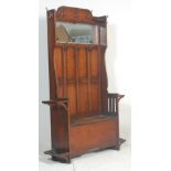 A Victorian 19th century oak hall stand settle. The hallstand with bench seat having a hinged lid