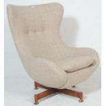 A retro mid century, circa 1970's swivel egg shaped easy chair - armchair. The chair having a 4