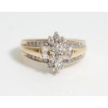 A 14 ct gold and diamond ladies ring having a central marquise cut diamond with further round and
