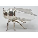 A silver plated and blue glass honey pot in the form of a bee having chased decorated hinged wings