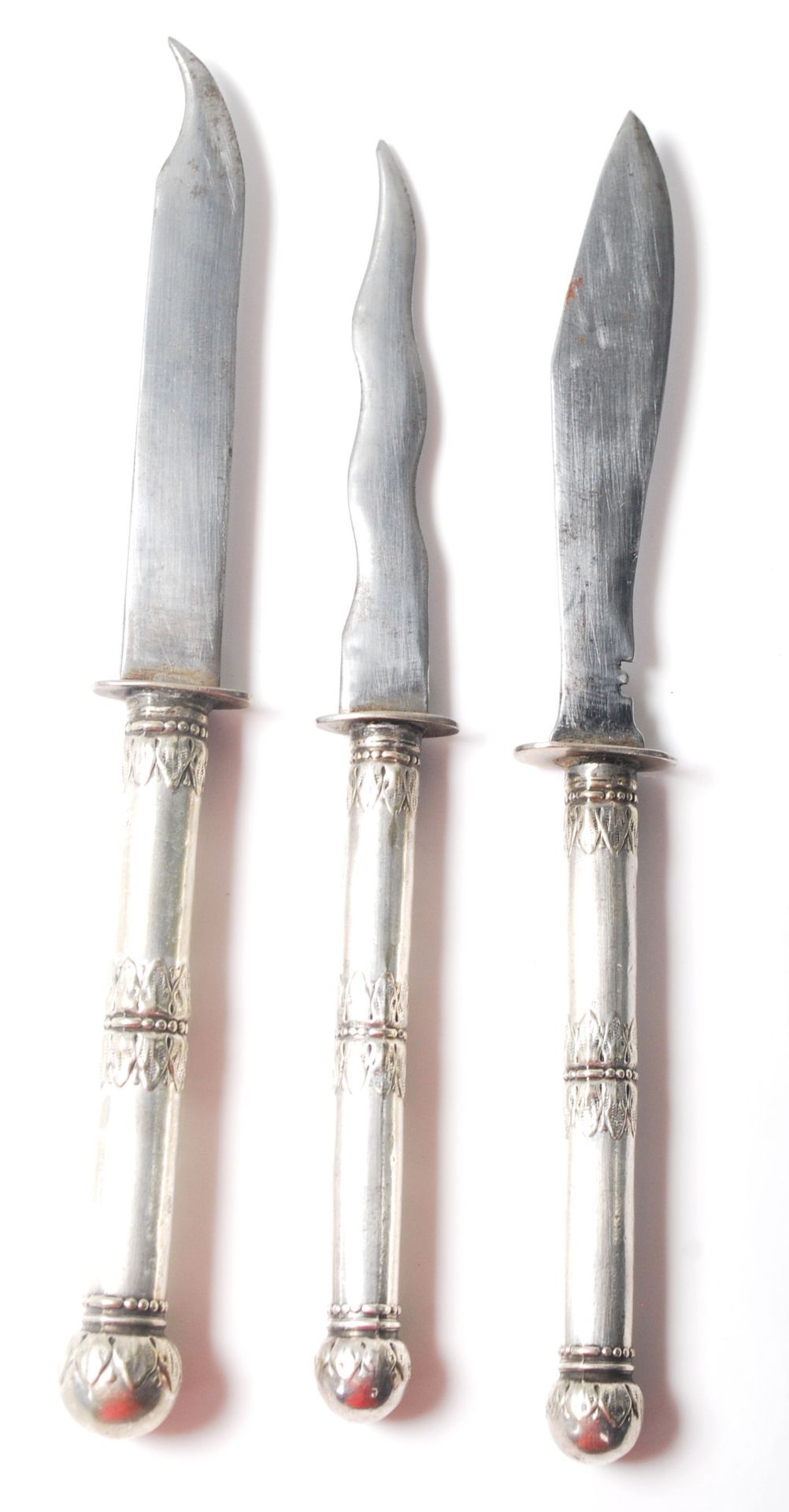 A group of three unusual silver handled 20th Century knives each having different shaped blades