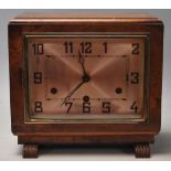 A vintage 1930's Art Deco mantle clock having a walnut case with a rectangular face and silvered