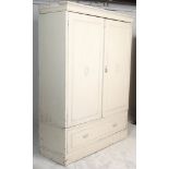 A 19th century Victorian shabby chic painted double wardrobe being raised on a plinth base with full