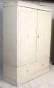 A 19th century Victorian shabby chic painted double wardrobe being raised on a plinth base with full