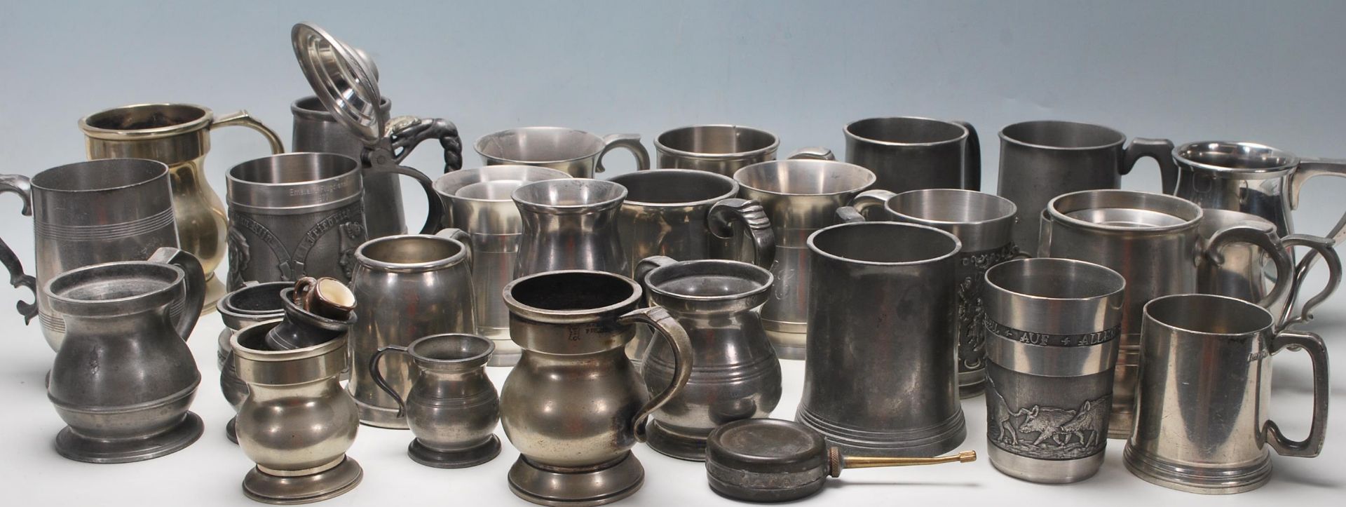 A collection of early 20th Century metalware & pewter drinking vessels / steins / flagons / jugs