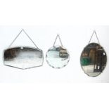 A group of three mid Century frameless mirrors to include a round bevelled edge mirror, an oval