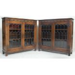 A pair of mid century Jacobean revival sold oak leaded glass bookcase cabinets in the manner of