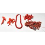 A collection of various vintage 20th Century red coral beads and jewellery pieces to include round