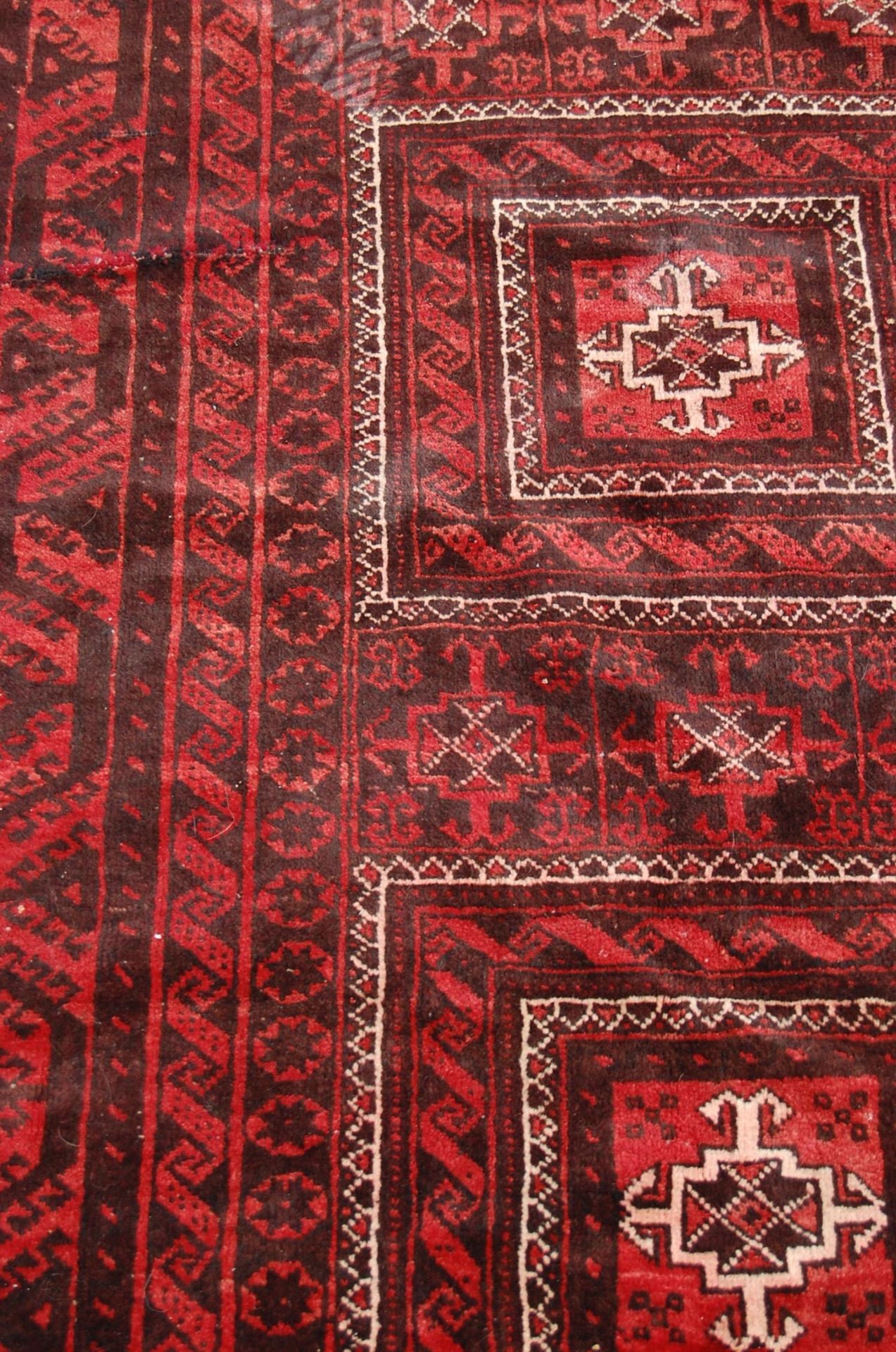 A pair of Islamic / Persian carpet rugs comprising of a red and black carpet having three - Image 7 of 9