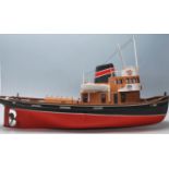 A vintage 20th Century scratch built remote control boat having a red and black hull with model