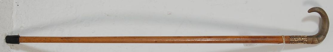 A late 20th Century vintage gentleman's walking stick / cane having a curved bone handle over a