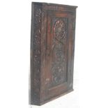 An 18th century George III carved oak corner cabinet having carved central fielded panel door