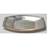 A silver hallmarked dish of lozenge form with raised edges. Central notation for SMH - NHJ Poole