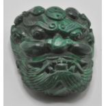 An unusual contemporary chines malachite belt buckle carved in a shape dragon head with ing and yang
