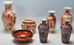 A collection of 20th Century Meiji revival period china comprising of three vases decorated with