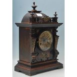 A early 20th century antique German mahogany mantel clock having brass dial with arabic numerals