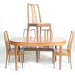 A retro 20th Century teak wood extendable dining table and matching chairs by Nathan. The oval table