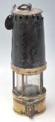 An early 20th Century Richard Johnson Clapham & Morris Ltd miners lamp having a brass cylindrical