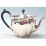 A silver hallmarked 1920's John Round & Son teapot having a oval shaped top with carved ebony handle