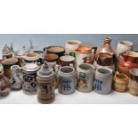 A large collection of 20th century assorted ceramic drinking vessels to include German stein