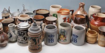 A large collection of 20th century assorted ceramic drinking vessels to include German stein
